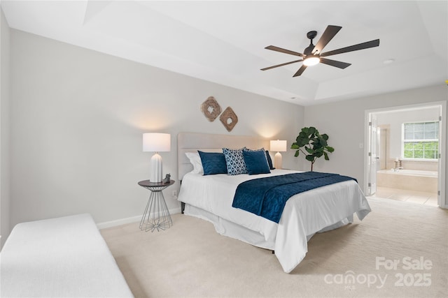 6803 Augustine Way, Charlotte, NC 28270 - bedroom featuring a tray ceiling, light colored carpet, connected bathroom, and a ceiling fan
