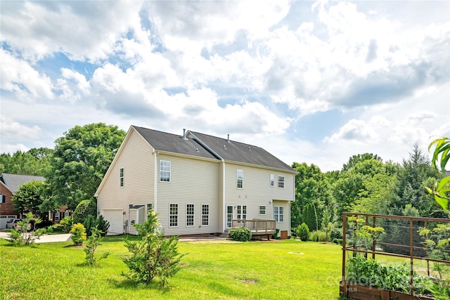 6803 Augustine Way, Charlotte, NC 28270 - back of house with a garage, a vegetable garden, a yard, and a deck