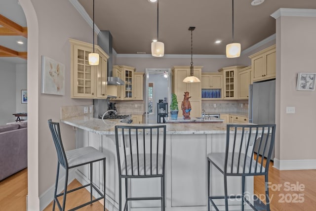 753 River Bend Dr, Granite Falls, NC 28630 - kitchen with cream cabinetry, stainless steel refrigerator, a peninsula, light wood finished floors, and backsplash