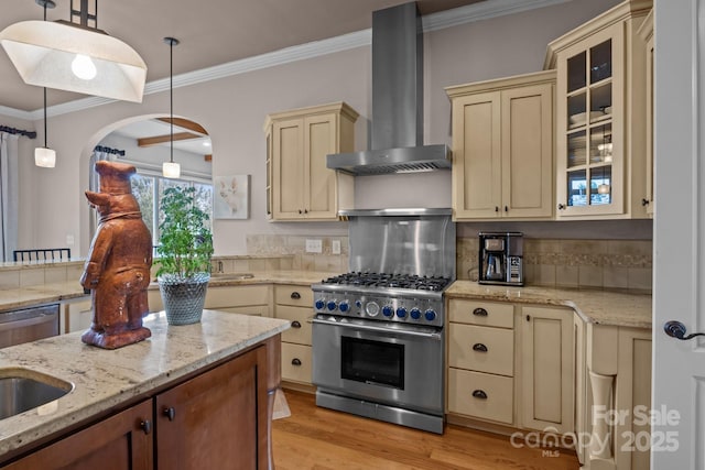 753 River Bend Dr, Granite Falls, NC 28630 - kitchen with cream cabinets, wall chimney exhaust hood, stainless steel appliances, decorative backsplash, and light wood-type flooring