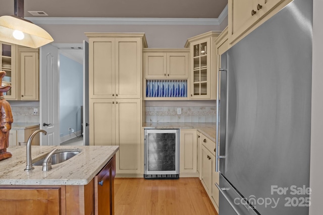 753 River Bend Dr, Granite Falls, NC 28630 - kitchen featuring stainless steel refrigerator, cream cabinets, wine cooler, crown molding, and light stone counters