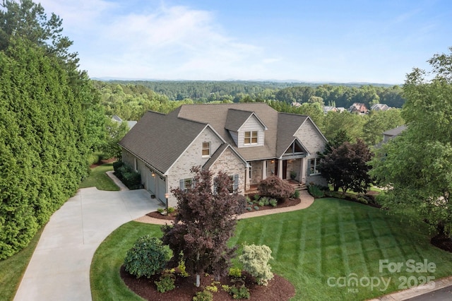 753 River Bend Dr, Granite Falls, NC 28630 - view of front facade featuring concrete driveway, a front lawn, a garage, a wooded view, and stone siding