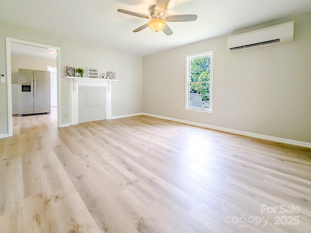 106 Cedar St, Spindale, NC 28160 - empty room featuring a wall mounted AC, a ceiling fan, light wood-style floors, and baseboards