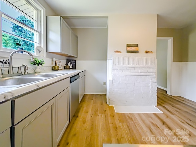 106 Cedar St, Spindale, NC 28160 - kitchen featuring a sink, dishwasher, light wood-style floors, light countertops, and baseboards