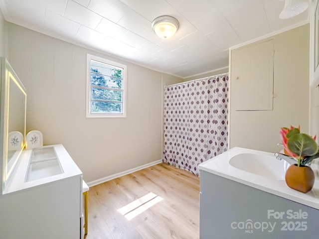 106 Cedar St, Spindale, NC 28160 - washroom featuring light wood-style floors, a sink, and ornamental molding
