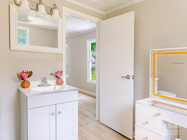 106 Cedar St, Spindale, NC 28160 - bathroom with ornamental molding, vanity, toilet, and wood finished floors