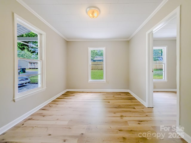 106 Cedar St, Spindale, NC 28160 - spare room featuring light wood-type flooring, healthy amount of natural light, ornamental molding, and baseboards