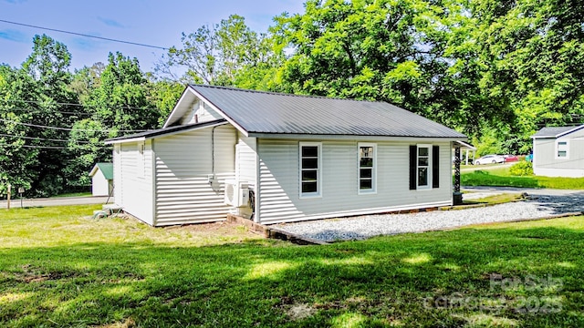106 Cedar St, Spindale, NC 28160 - view of side of home with a lawn, ac unit, and metal roof