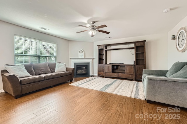 4151 Granite St, Midland, NC 28107 - living room with a ceiling fan, wood finished floors, and a fireplace with flush hearth
