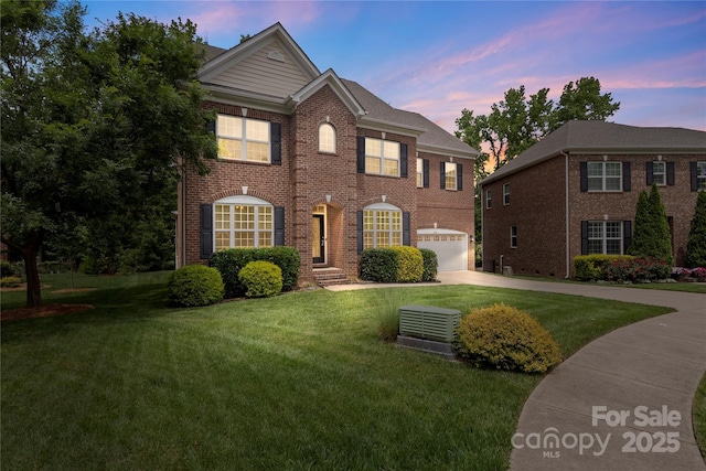 1830 Alden Oaks Ln, Charlotte, NC 28270 - colonial-style house with driveway, a yard, brick siding, and a garage