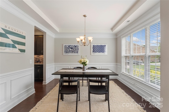 1830 Alden Oaks Ln, Charlotte, NC 28270 - dining area with a chandelier, healthy amount of natural light, dark wood-style floors, a tray ceiling, and a wainscoted wall