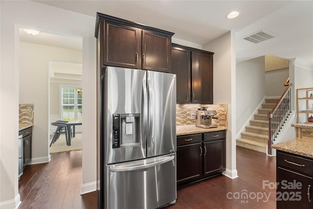 1830 Alden Oaks Ln, Charlotte, NC 28270 - kitchen featuring stainless steel fridge, dark wood-style flooring, light stone counters, dark brown cabinets, and backsplash