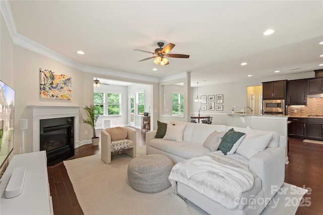1830 Alden Oaks Ln, Charlotte, NC 28270 - living room featuring ceiling fan, dark wood-style flooring, recessed lighting, a glass covered fireplace, and ornamental molding