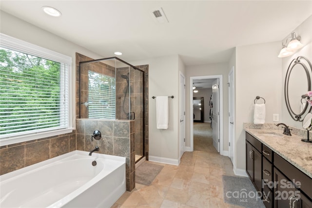 1830 Alden Oaks Ln, Charlotte, NC 28270 - bathroom featuring healthy amount of natural light, a garden tub, vanity, a shower stall, and recessed lighting