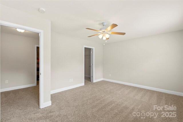 1830 Alden Oaks Ln, Charlotte, NC 28270 - unfurnished bedroom featuring carpet, a walk in closet, a closet, and a ceiling fan