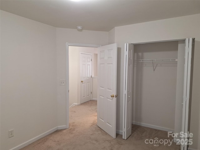 8838 Wandering Creek Way, Charlotte, NC 28227 - unfurnished bedroom featuring light carpet and a closet