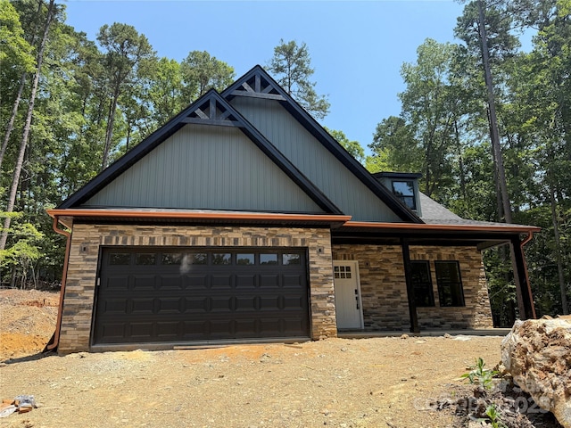 1923 Fairfield Rd, Mount Gilead, NC 27306 - view of front facade with stone siding, driveway, and a garage