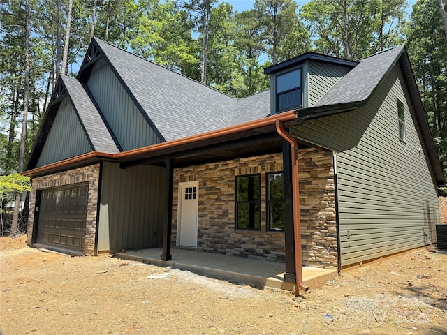 1923 Fairfield Rd, Mount Gilead, NC 27306 - view of front of home featuring stone siding, roof with shingles, a garage, and driveway