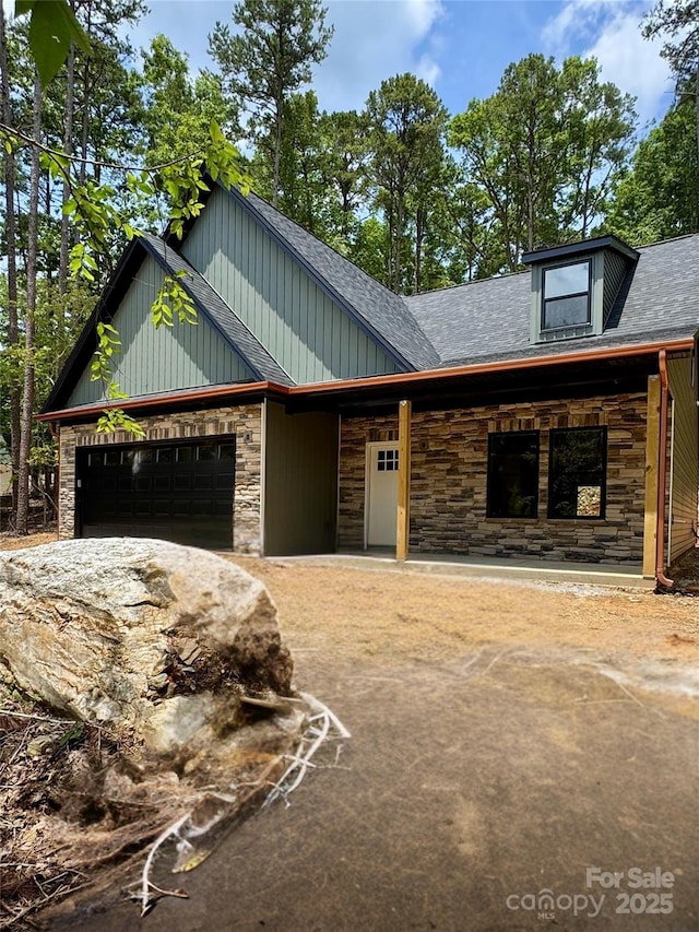 1923 Fairfield Rd, Mount Gilead, NC 27306 - view of front facade featuring stone siding, a garage, and roof with shingles
