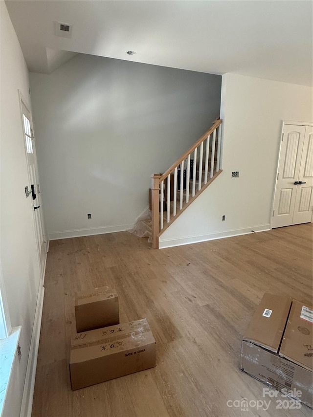 1923 Fairfield Rd, Mount Gilead, NC 27306 - unfurnished living room with wood finished floors, stairs, and lofted ceiling