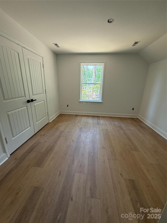 1923 Fairfield Rd, Mount Gilead, NC 27306 - unfurnished bedroom with wood-type flooring, a closet, and lofted ceiling