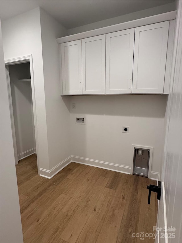 1923 Fairfield Rd, Mount Gilead, NC 27306 - washroom with wood finished floors, electric dryer hookup, washer hookup, and cabinet space