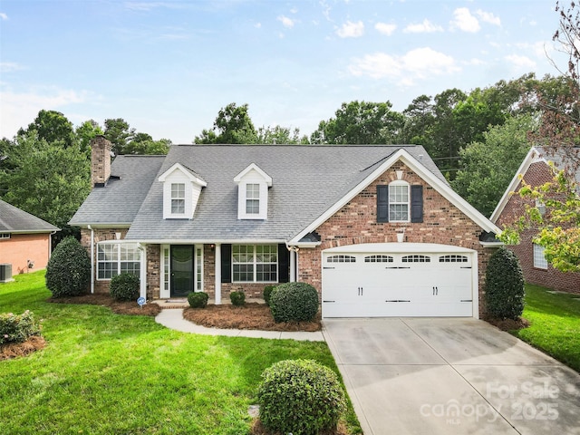 5707 Sustar Dr, Monroe, NC 28110 - view of front of house featuring concrete driveway, a front lawn, a chimney, and brick siding