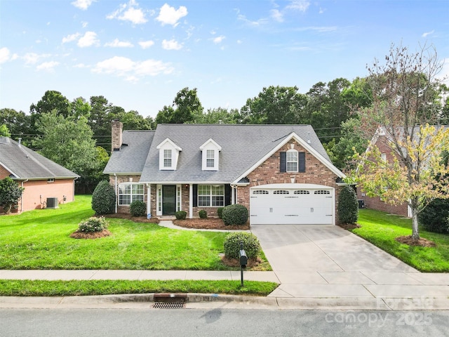 5707 Sustar Dr, Monroe, NC 28110 - view of front of house with brick siding, driveway, a chimney, a front lawn, and a garage
