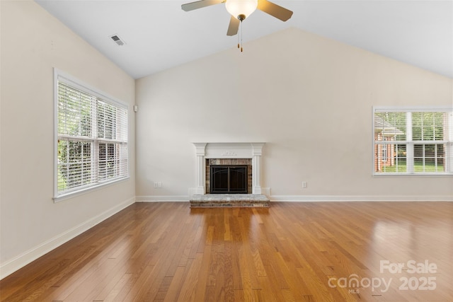 5707 Sustar Dr, Monroe, NC 28110 - unfurnished living room with a fireplace, vaulted ceiling, light wood finished floors, healthy amount of natural light, and a ceiling fan