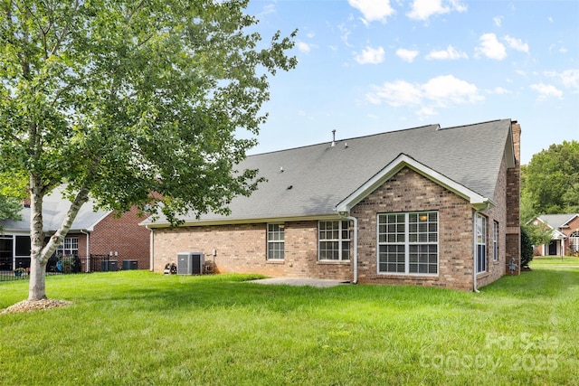 5707 Sustar Dr, Monroe, NC 28110 - rear view of house featuring brick siding, a yard, a shingled roof, and a chimney