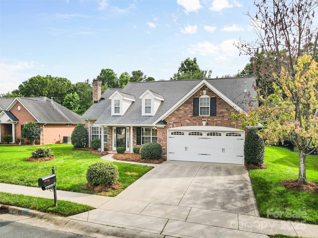 5707 Sustar Dr, Monroe, NC 28110 - view of front of property with driveway, a front lawn, a garage, a chimney, and brick siding