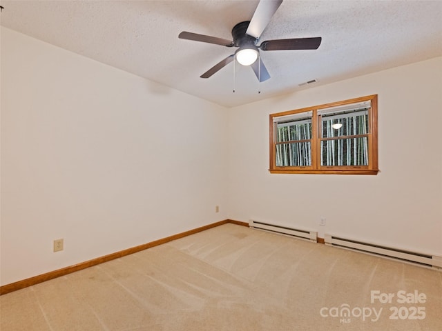 848 Eagles Ridge Rd, Sylva, NC 28779 - carpeted spare room with baseboard heating, ceiling fan, baseboards, and a textured ceiling