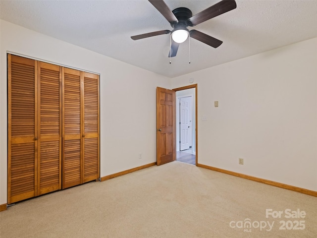 848 Eagles Ridge Rd, Sylva, NC 28779 - unfurnished bedroom featuring light carpet, baseboards, a closet, and ceiling fan