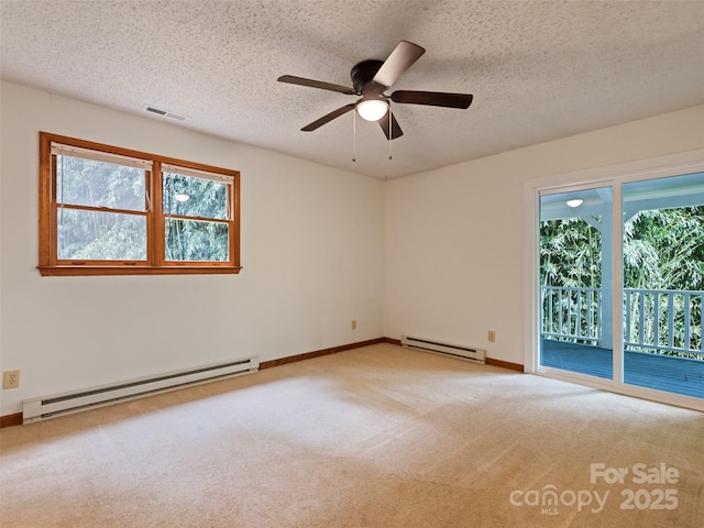848 Eagles Ridge Rd, Sylva, NC 28779 - carpeted spare room with a baseboard radiator, plenty of natural light, a ceiling fan, and a textured ceiling