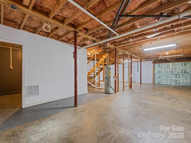 848 Eagles Ridge Rd, Sylva, NC 28779 - unfinished below grade area featuring electric water heater and stairway