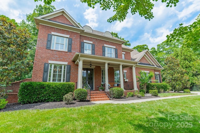 2004 Viscount Dr, Matthews, NC 28104 - colonial house featuring brick siding, a front yard, and a porch