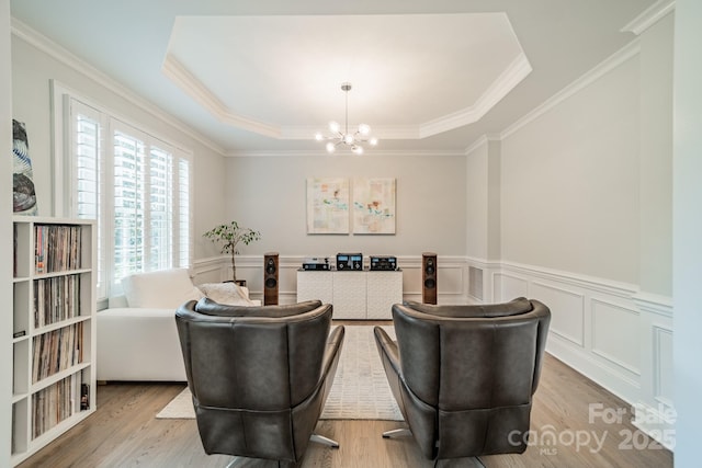 2004 Viscount Dr, Matthews, NC 28104 - sitting room featuring a chandelier, a raised ceiling, ornamental molding, wainscoting, and wood finished floors