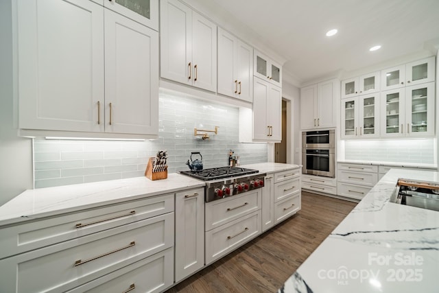 2004 Viscount Dr, Matthews, NC 28104 - kitchen featuring stainless steel gas stovetop, white cabinets, decorative backsplash, dark wood-style floors, and light stone countertops