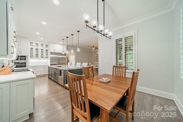 2004 Viscount Dr, Matthews, NC 28104 - dining room with crown molding, a ceiling fan, light wood finished floors, recessed lighting, and a chandelier