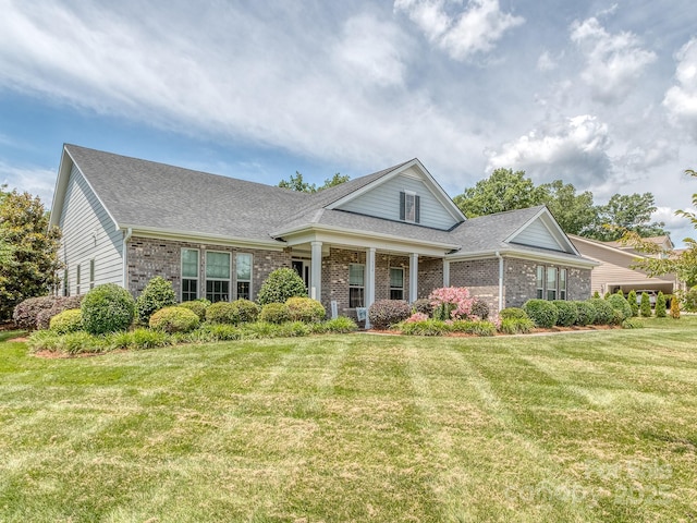 314 Candella Dr, Matthews, NC 28104 - view of front of home with brick siding, roof with shingles, and a front lawn