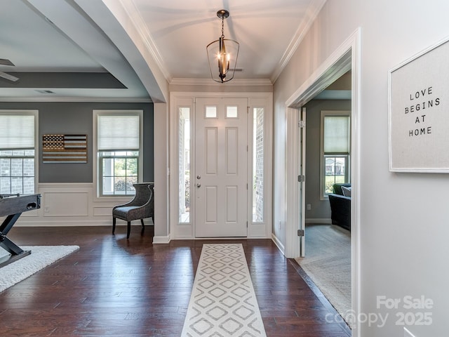 314 Candella Dr, Matthews, NC 28104 - entryway featuring dark wood-type flooring, ornamental molding, a chandelier, and wainscoting