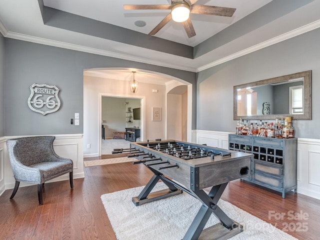 314 Candella Dr, Matthews, NC 28104 - rec room featuring arched walkways, a raised ceiling, ceiling fan, wood finished floors, and wainscoting