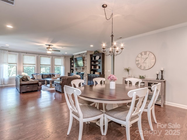 314 Candella Dr, Matthews, NC 28104 - dining space featuring crown molding, a ceiling fan, a chandelier, baseboards, and wood finished floors