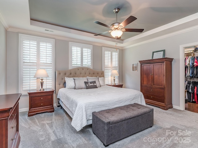 314 Candella Dr, Matthews, NC 28104 - bedroom featuring a raised ceiling, light carpet, a walk in closet, a closet, and ornamental molding