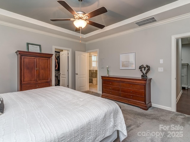 314 Candella Dr, Matthews, NC 28104 - bedroom with a tray ceiling, baseboards, carpet, ornamental molding, and a spacious closet