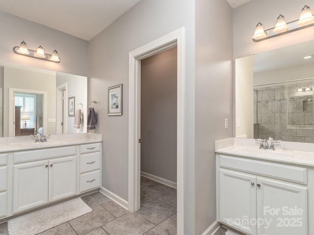 314 Candella Dr, Matthews, NC 28104 - full bath featuring two vanities, tile patterned floors, and baseboards