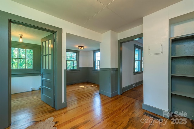 12 Mountain View Ave, Black Mountain, NC 28711 - empty room featuring wood finished floors, a wainscoted wall, and built in shelves