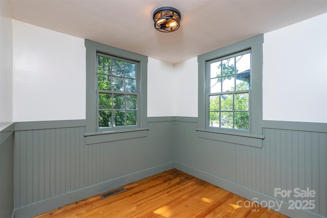 12 Mountain View Ave, Black Mountain, NC 28711 - spare room with a wainscoted wall and wood finished floors