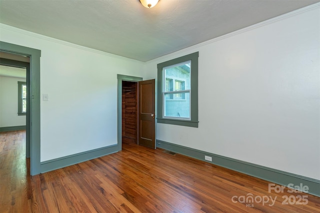 12 Mountain View Ave, Black Mountain, NC 28711 - unfurnished room featuring healthy amount of natural light, ornamental molding, and wood finished floors