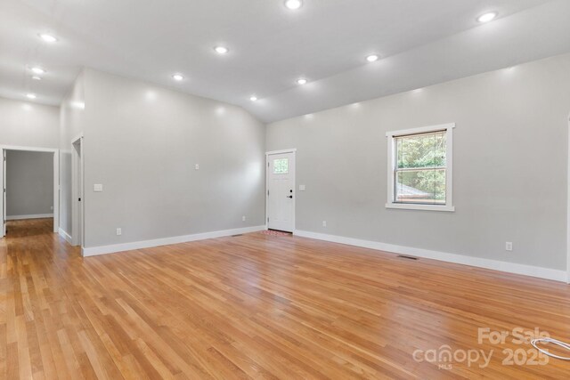 1844 Bellcroft Ln, Lenoir, NC 28645 - empty room with light wood-style floors, lofted ceiling, and recessed lighting